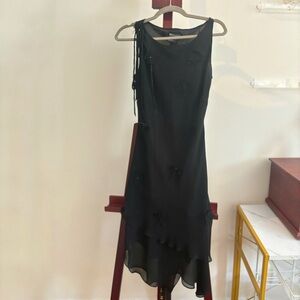 Black vintage dress with a tiered hem and floral appliques